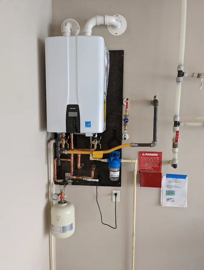 Professional plumber installing copper piping in a Laplace home